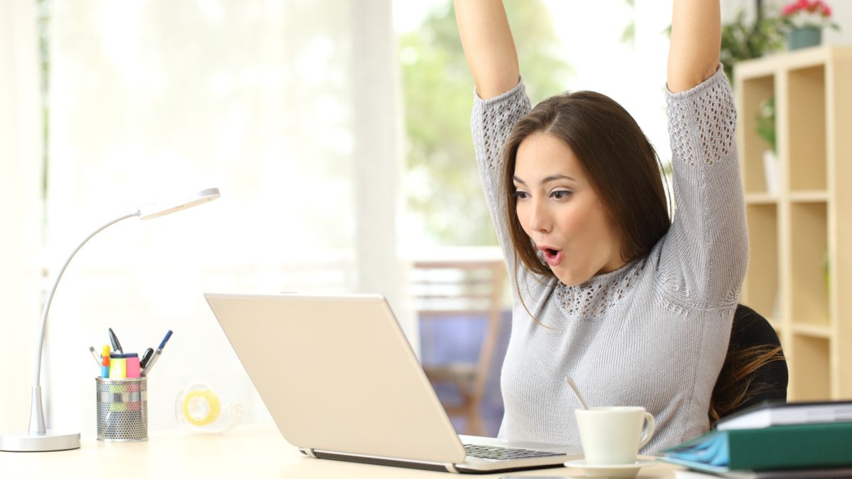 happy woman using a Windows 10 laptop